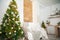 Details of the decorated New Year`s interior. Scandinavian living room and kitchen for Christmas. The comfort of homely rustic dec