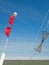 Details of a fishing boat: buoys with red flags and fishing net