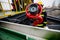 Details with the hands of a firefighter holding a fire suppression system hydrant on a hospital helipad