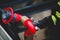 Details with the hands of a firefighter holding a fire suppression system hydrant on a hospital helipad