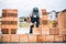 Details of industrial bricklayer installing bricks on construction site