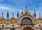 Details of main facade of St Mark's cathedral in Venice. Italy. UNESCO World Heritage city, blue sky, clouds, mosaics