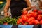 Details of a man choosing hot green peppers sweet red peppers also on the shelf on the fruits and vegetables aisle in a store