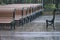 Details of park benches before assembling in public park, lots of wooden benches during rain outside, selective focus