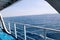 Details of passenger boat. Cruise ship deck. Picturesque view from ship deck on navy blue sea, horizon and sky during vacation.