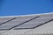 Details of photovoltaic solar power generation panels on the roof top against a clear blue summer sky in Arizona