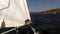 Details and rope close-up of white sails on deck of moving sailing yacht .