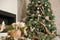 Details Rustic living room for Christmas. Fireplace and decor of fir branches and Rustic flowers for New Year close-up and copy sp