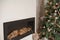 Details Rustic living room for Christmas. Fireplace and decor of fir branches and Rustic flowers for New Year close-up and copy sp