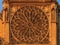 Details of the southern facade of Notre Dame de Paris Cathedral facade with the rose window and ornate tracery in the warm light