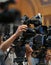 Details with television video cameras and recording equipment during a press event