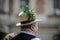 Details with the traditional Romanian straw hat of a senior man, adorned with flowers, leaves and peacock feathers