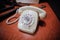 Details with a white old fashioned dial rotary phone from the communist Romania era