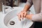 Details of woman scrubing and washing hands at home . Hygiene and body cleaning concept detail, pandemic