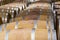 Details of wooden barrels filled with maturing wine in a bodega near Valencia, Spain