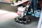 Details of worker finishing concrete screed with power trowel machine on construction site