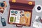 Detective briefcase. Open suitcase with spy surveillance tools investigation equipment on police desk, secret agent bag