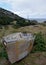 Deteriorating dory fishing boat on land in a meadow