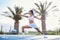 Determination is the difference. a young woman doing yoga on a tennis court.