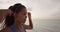 Determination - Female Runner Fixing Ponytail At Beach During Sunset