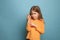 The determination. Teen girl on a blue background. Facial expressions and people emotions concept