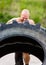 Determined Athlete Doing Tire-Flip Exercise