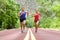 Determined Athletes Running On Road Against Trees