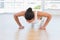 Determined beautiful woman doing push ups in gym