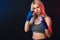 Determined blonde female boxer in blue handwraps gets prepared for fight