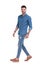 Determined casual man walking while wearing blue shirt