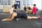 Determined Female Athlete Doing Stretching Exercise At Health Club