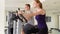 Determined fit sportive positive couple working out on exercise bikes at gym