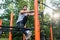 Determined handsome man doing extreme single-leg squats