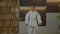 Determined multiethnic karate boy in karate gi making ritual bow indoors