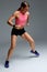 Determined muscular female athlete workout, raising leg and doing stretching exercises. Sport woman in sportswear