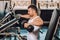 Determined muscular man exercising with dumbbells in gym