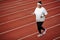 Determined overweight African woman jogging on running track