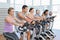 Determined people working out at spinning class