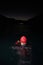 A determined professional triathlete undergoes rigorous night time training in cold waters, showcasing dedication and