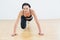 Determined sporty woman doing push ups in fitness studio