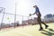 Determined sporty young woman playing padel in court