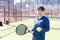 Determined sporty young woman playing padel in court