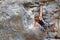 Determined to reach the top. A young rock climber scaling a mountain - copyspace.