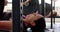 Determined unaltered biracial woman weight training at gym bench pressing barbell, in slow motion