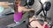 Determined unaltered diverse women exercising on rowing machines at gym, in slow motion