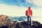 determined woman backpacker hiking on mountain peak