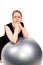 Determined woman leaning over a pilates ball