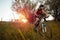 Determined young man riding mountain bike in a park