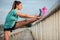 Determined young woman stretching legs after a hard outdoor urban workout