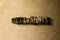 DETERMINES - close-up of grungy vintage typeset word on metal backdrop